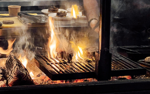 Steaks Cooking On Coals At Carnival At Escape To Freight Island In Manchester Cover