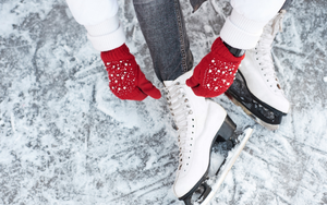 Ice Skater Tying Laces On The Ice