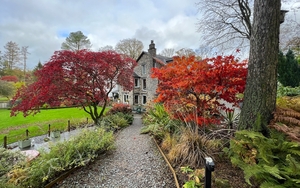 Gilpin Lodge Lakehouse Surrounded By Beauitful Gardens With Trees In Autumn Colours