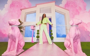 A Woman In A Pale Green Outfit Holds Two Pink Dog Statues On A Leash At 202 Kitchen Spinningfields Manchester