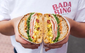Hands Holding A Sandwich Cut In Half From Bada Bing