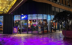 The Exterior Of Nells Pizza In Kampus Manchester With Fairy Lights And Colourful Lighting At Night