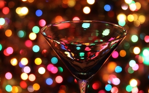 An Image Of A Martini Cocktail Glass With Xmas Fairy Lights In The Background