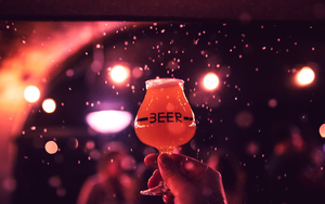 A Glass Of Beer Held In The Air At Manchester Craft Beer Festival Set To Be Held In Mayfield Depot In Manchester