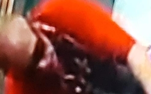 Man in wig and dress holds up Nice 'n' Naughty